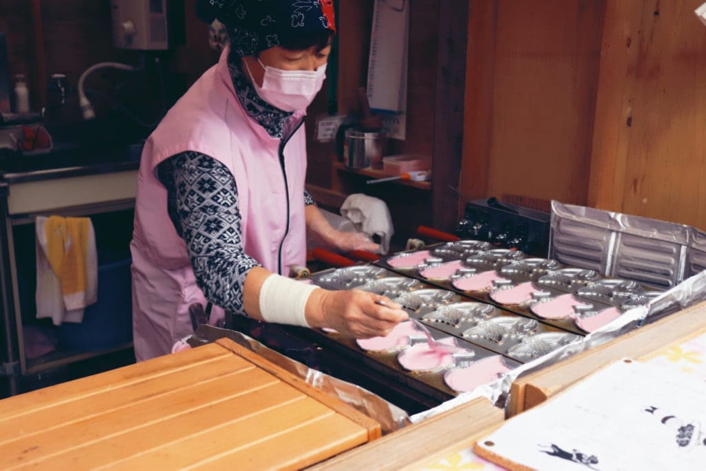 Kawazu Sakura Festival - lady making pink taiyaki