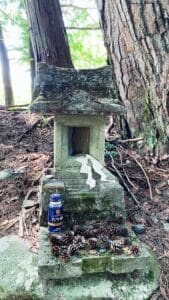 Hokora (miniature shrine) with offerings