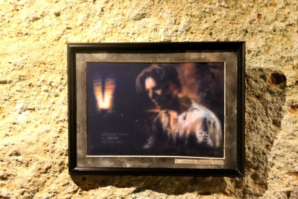 A snapshot from X Japan's music video for Forever Love hangs on the walls.