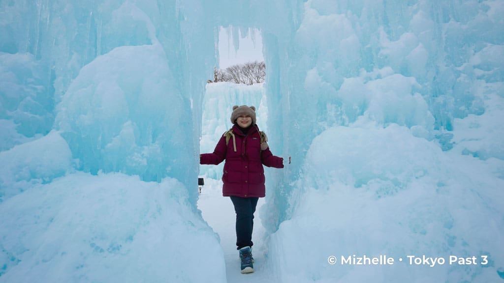 Mizhelle posing with snow sculpture at the Lake Shikotsu Ice Festival