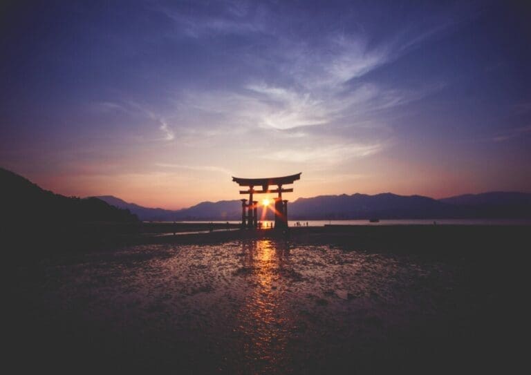 A breathtaking sunset over the famous historic floating torii of Miyajima, Japan